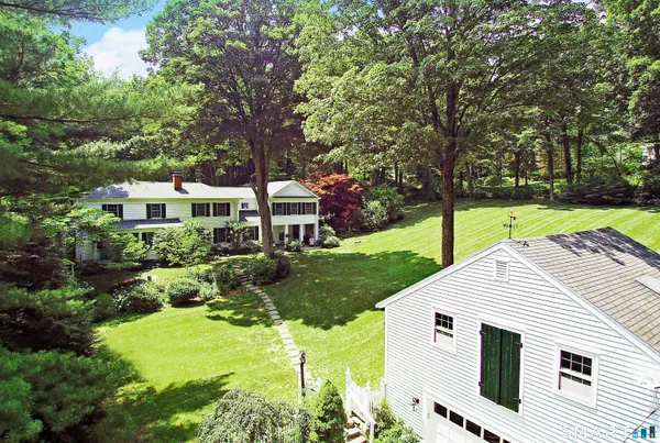 a aerial view of a house with yard and green space