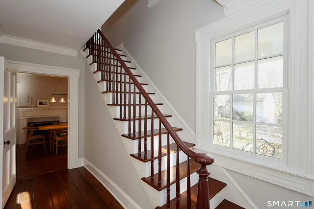 a view of entryway with wooden floor and stairs