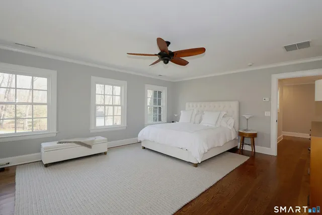 a spacious bedroom with a bed and a window