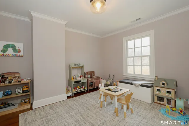 a work room with furniture a air conditioner vent and a window