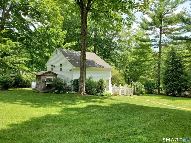a view of a house with yard and tree s