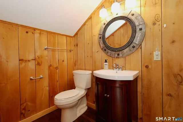 a bathroom with a sink a toilet and a mirror