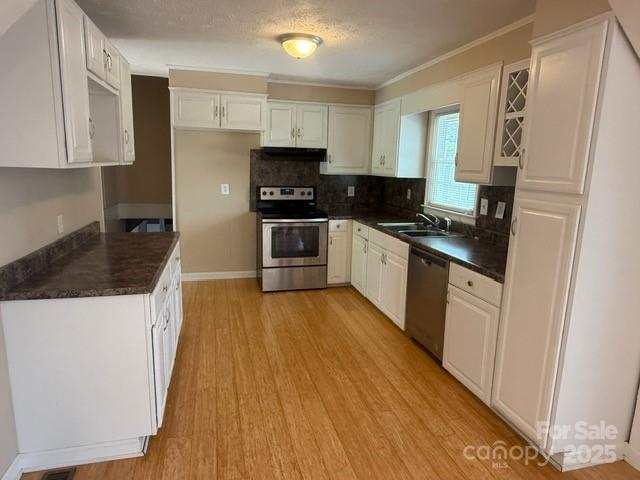 2205 Olde Well Road Hudson, NC 28638 - Photo 4 of 23 a kitchen with stainless steel appliances granite countertop a refrigerator a stove top oven a sink and dishwasher with wooden floor