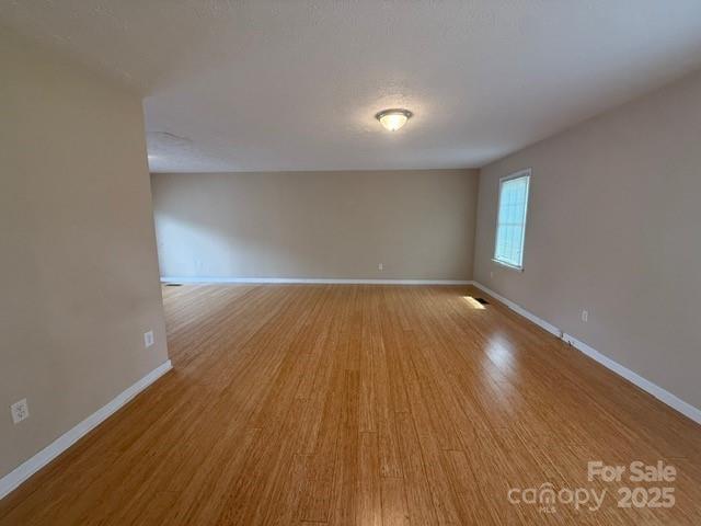 2205 Olde Well Road Hudson, NC 28638 - Photo 6 of 23 an empty room with wooden floor and windows