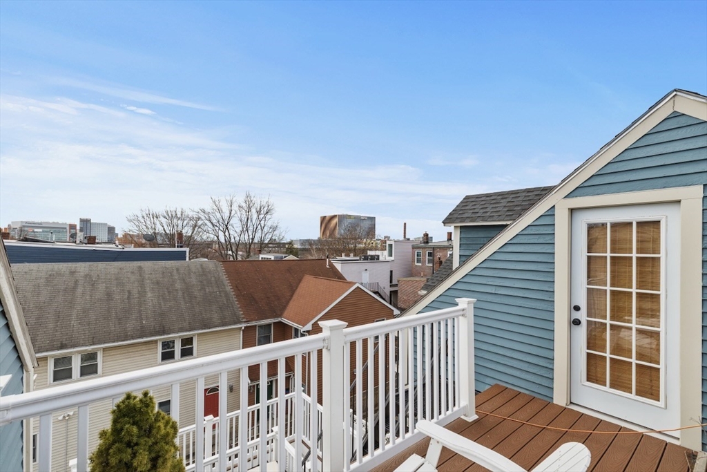 38 Mead Street, Unit 2 Boston, MA 02129 - Photo 12 of 14 a view of a balcony with two chairs and a floor to ceiling window