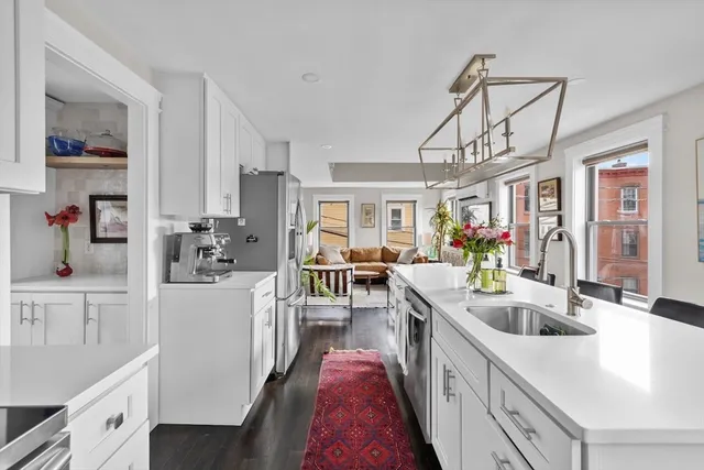 a very nice looking open kitchen with a dining table and chairs
