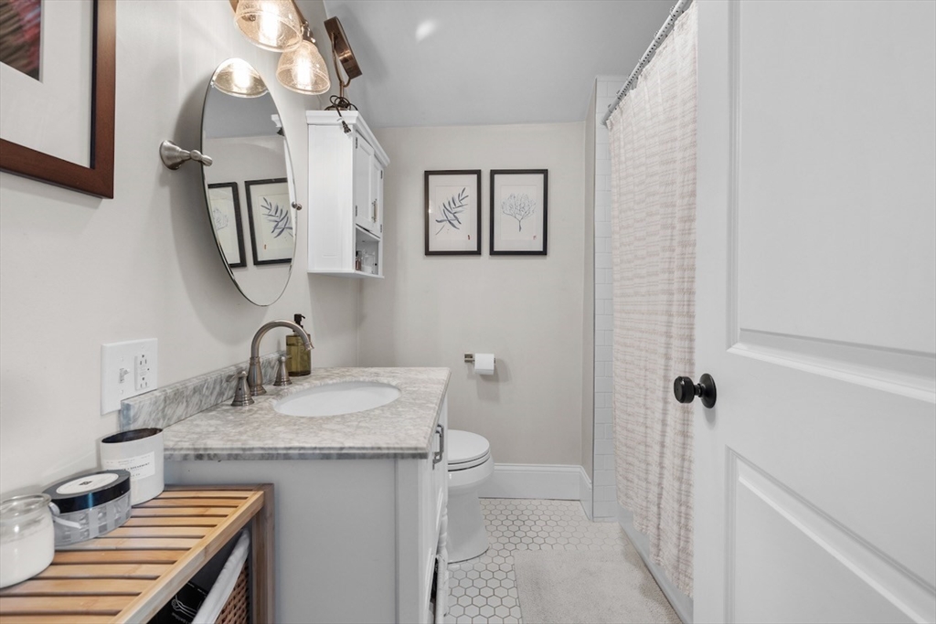 38 Mead Street, Unit 2 Boston, MA 02129 - Photo 8 of 14 a bathroom with a granite countertop sink a toilet and mirror