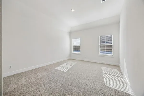 a view of an empty room with wooden floor and closet