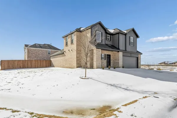 a view of a house with a snow on the road
