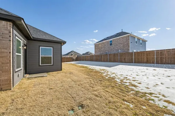 a view of houses with wooden fence