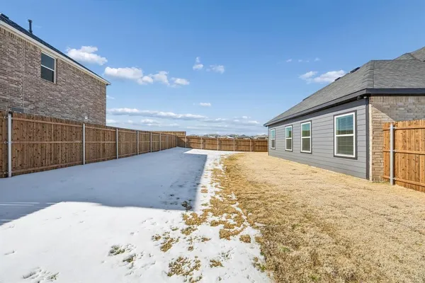 a view of a house with a snow in the yard