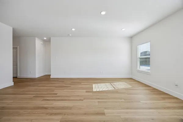 a view of a kitchen with a sink and wooden floor