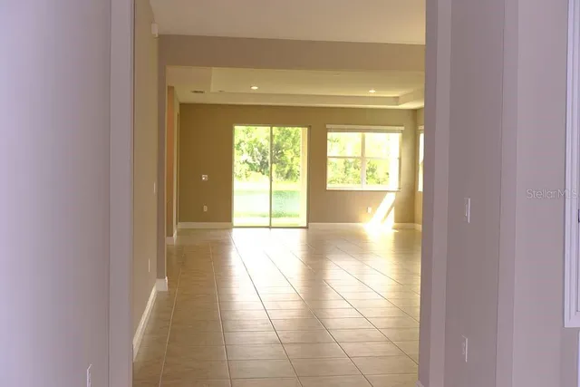 a view of an empty room and a window