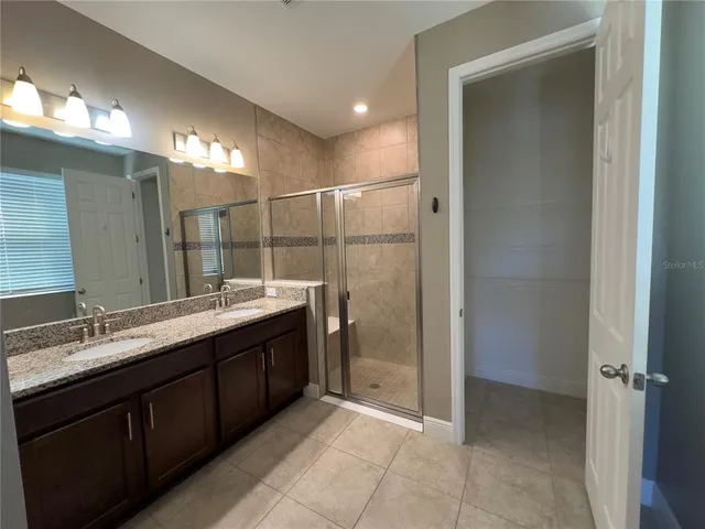 a bathroom with a double vanity sink and a mirror