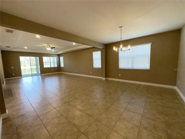 a view of an empty room and a window