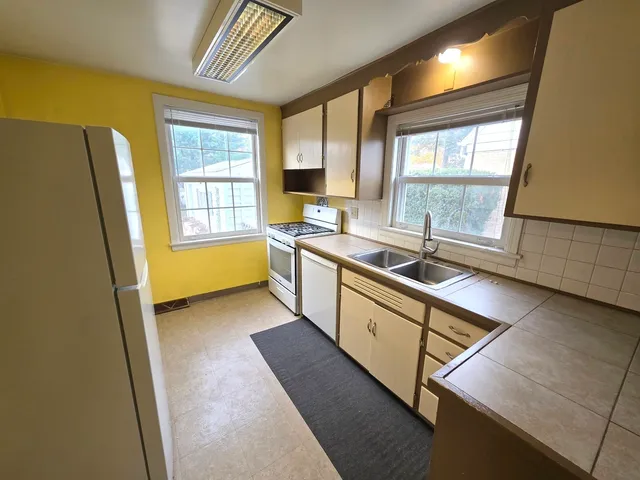 a kitchen with sink cabinets and appliances