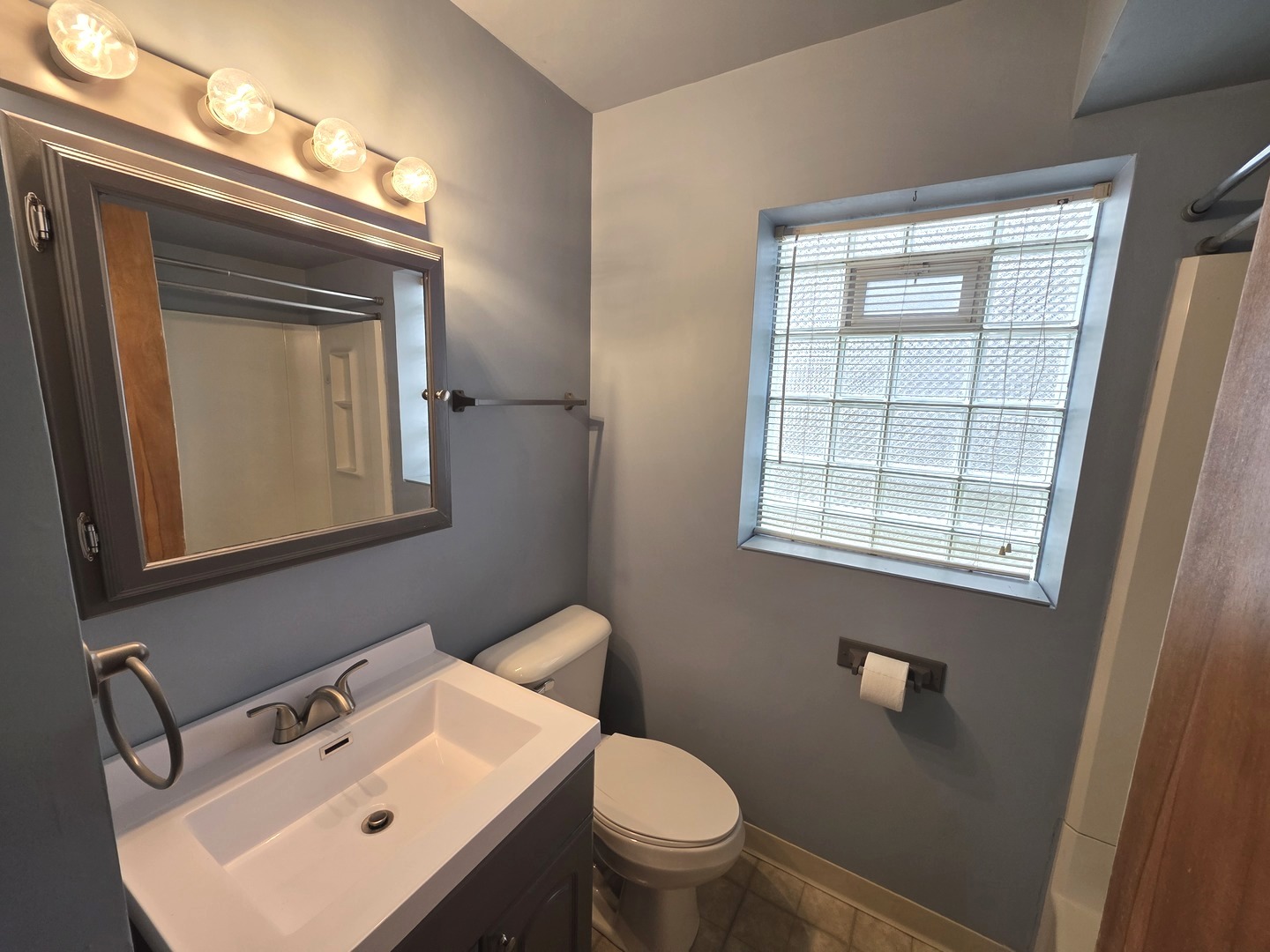 436 South Arlington Heights Road Arlington Heights, IL 60005 - Photo 8 of 16 a bathroom with a toilet sink vanity and mirror