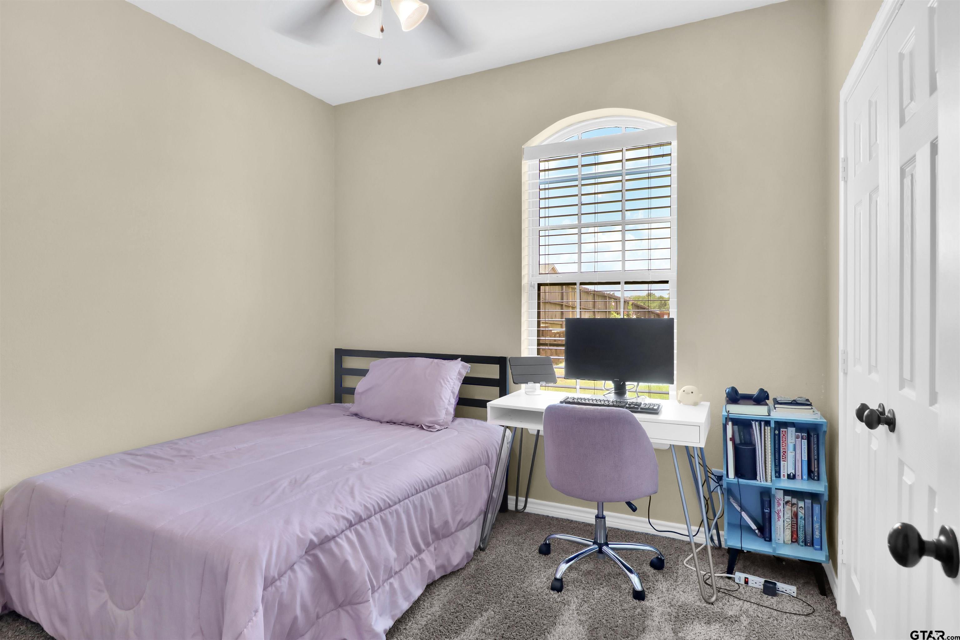 112 Letha Court Tyler, TX 75702 - Photo 13 of 45 a bedroom with a bed and a book shelf