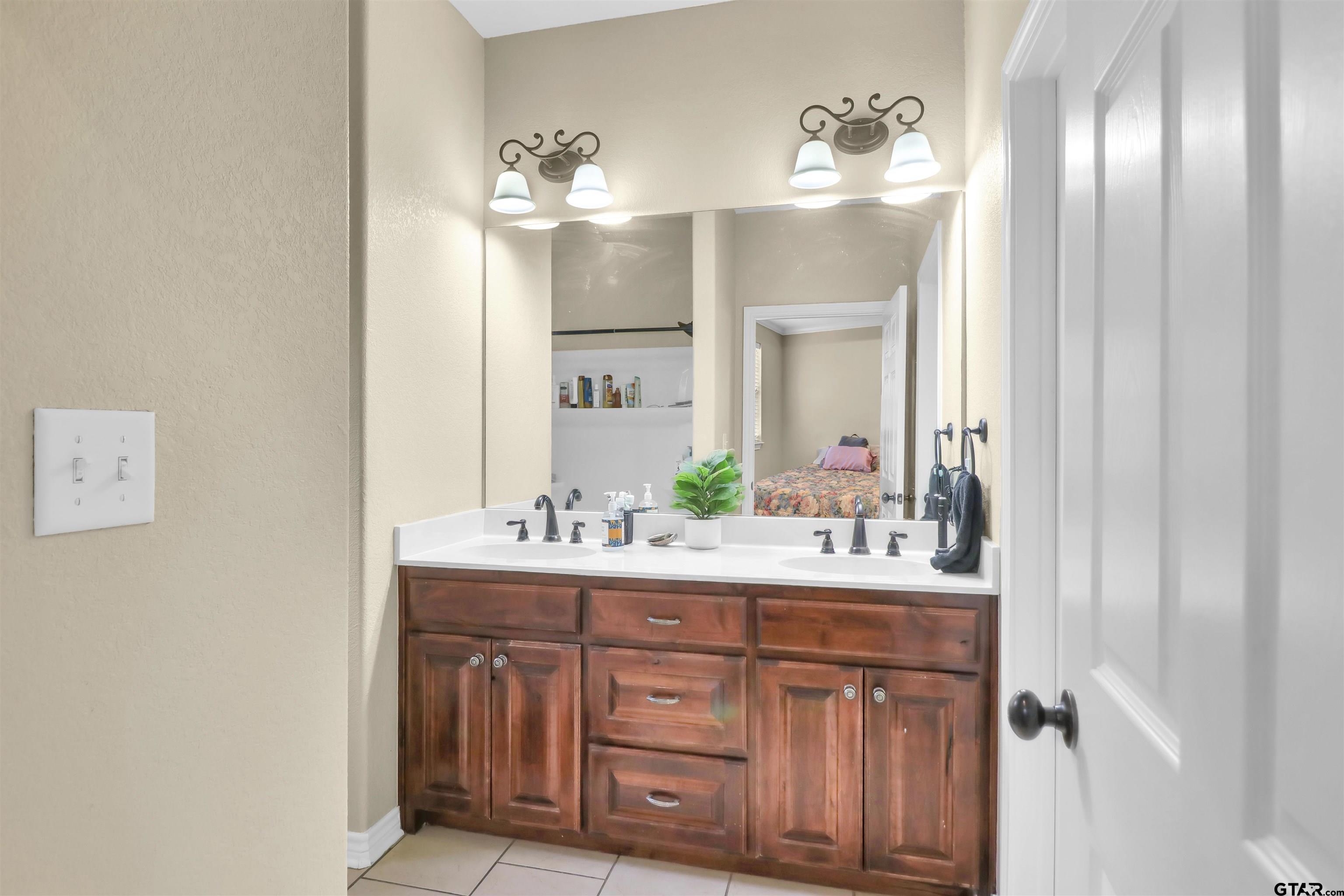 112 Letha Court Tyler, TX 75702 - Photo 16 of 45 a bathroom with a double vanity sink and a mirror