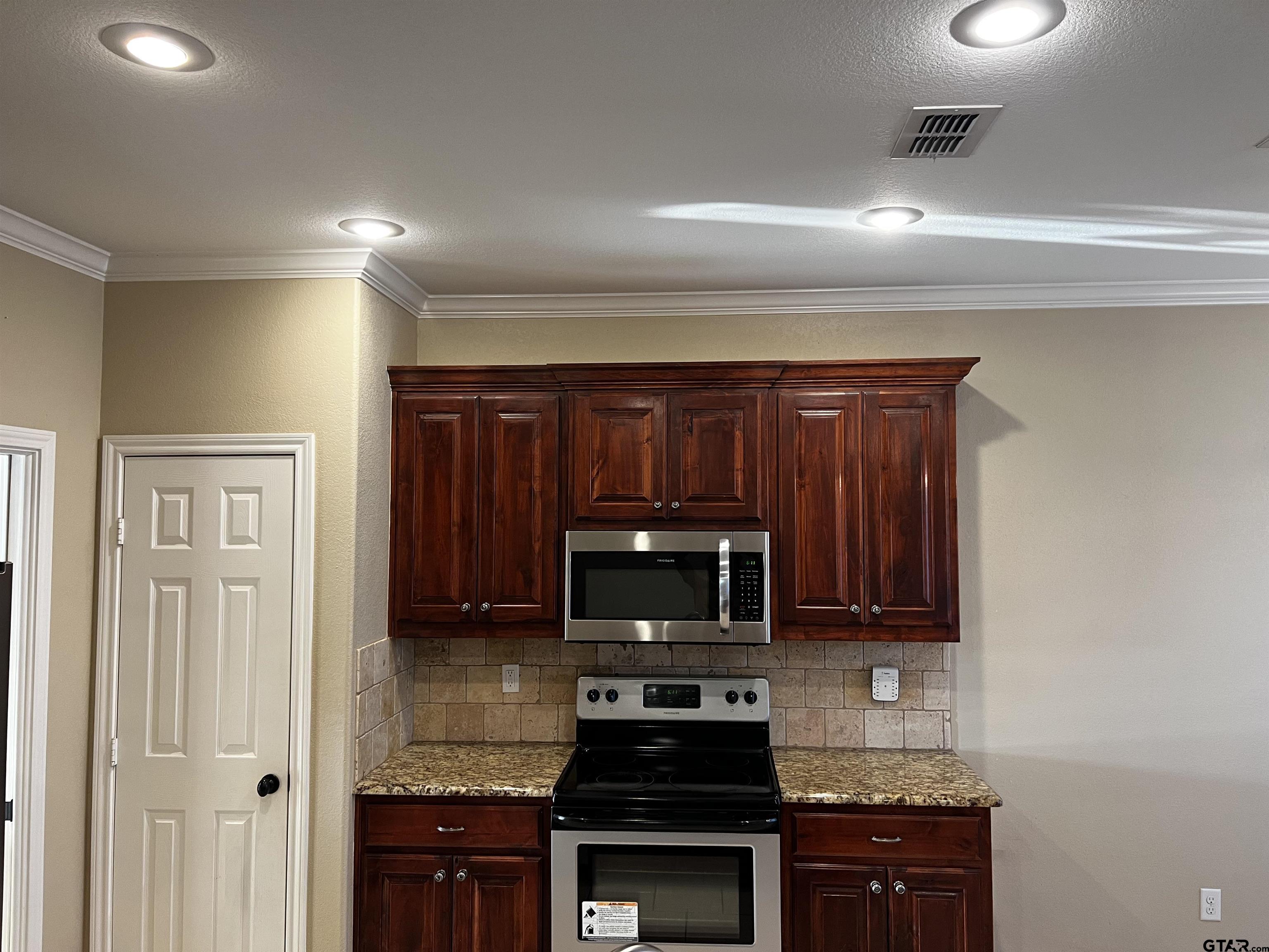 112 Letha Court Tyler, TX 75702 - Photo 23 of 45 a kitchen with a sink a stove and cabinets