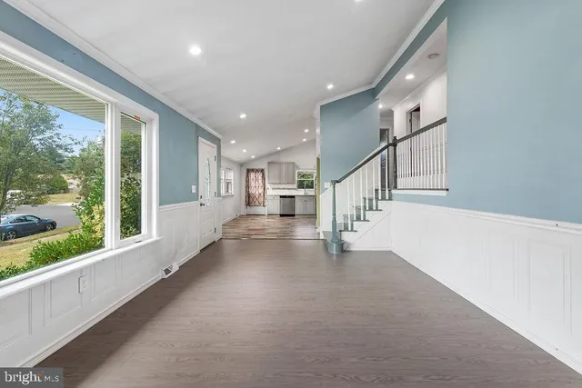 a view of staircase with white walls and windows