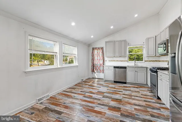 a kitchen with stainless steel appliances granite countertop a stove and a refrigerator