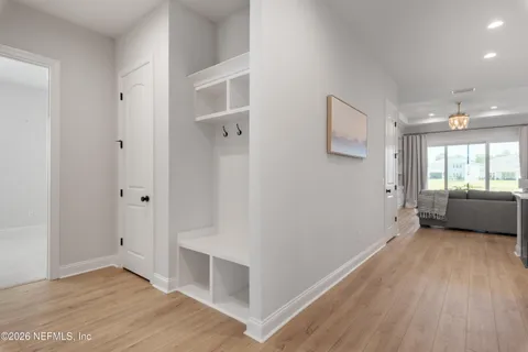 a view of a big room with wooden floor and windows