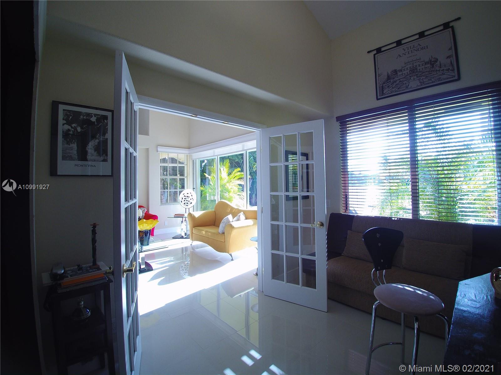 1055 San Luis Rey Weston, FL 33326 - Photo 11 of 36 a living room with furniture and a large window