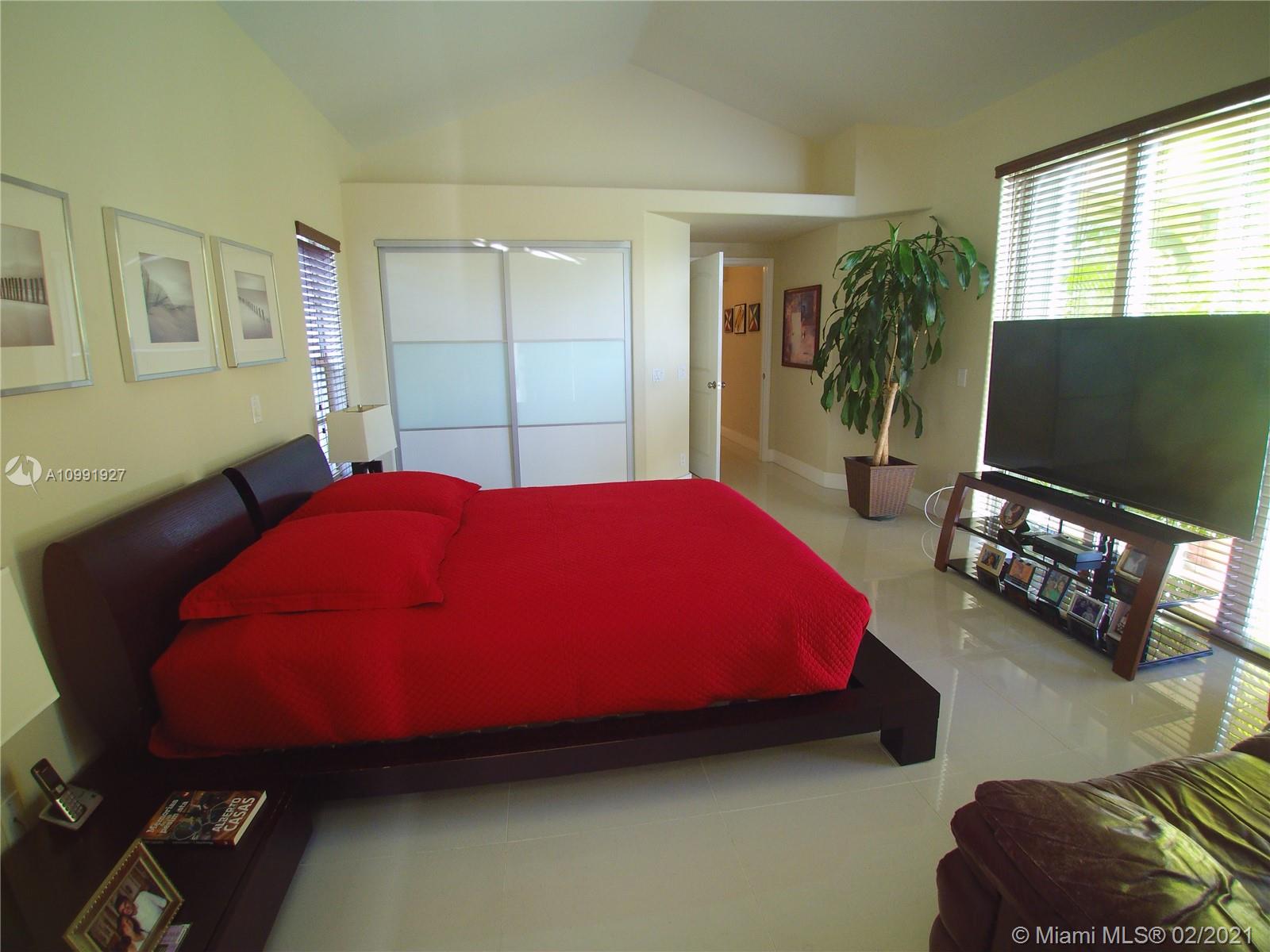 1055 San Luis Rey Weston, FL 33326 - Photo 16 of 36 a bedroom with bed and a window