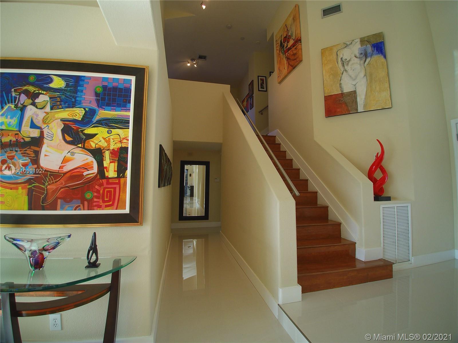 1055 San Luis Rey Weston, FL 33326 - Photo 17 of 36 a view of an entryway with wooden floor