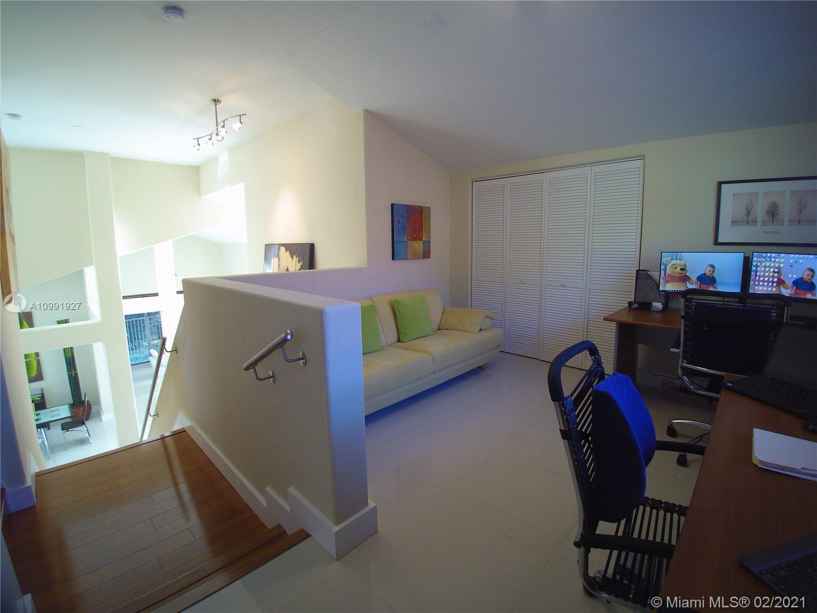 1055 San Luis Rey Weston, FL 33326 - Photo 20 of 36 a living room with furniture and a flat screen tv