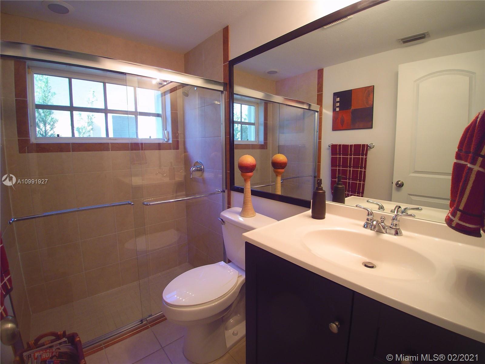 1055 San Luis Rey Weston, FL 33326 - Photo 24 of 36 a bathroom with a sink toilet and shower