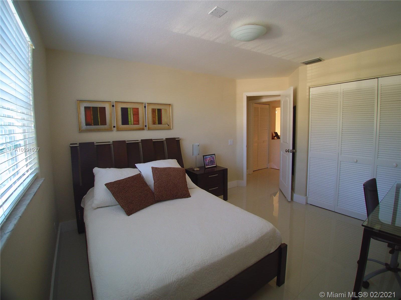 1055 San Luis Rey Weston, FL 33326 - Photo 28 of 36 a bedroom with a bed and wooden floor