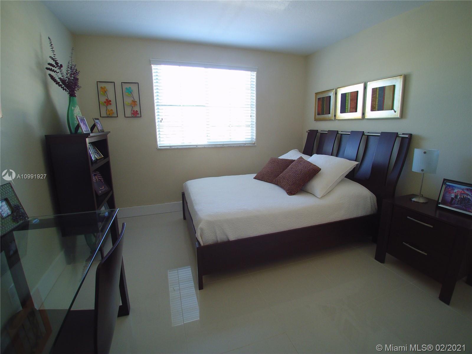 1055 San Luis Rey Weston, FL 33326 - Photo 29 of 36 a bedroom with a bed furniture and a window