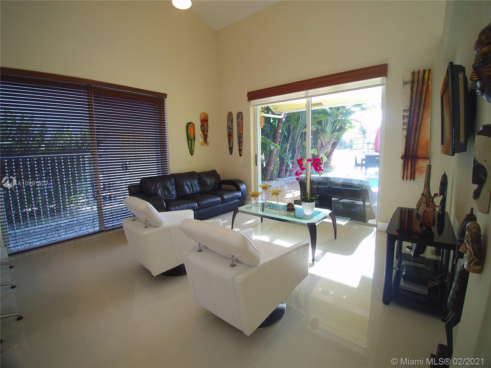 1055 San Luis Rey Weston, FL 33326 - Photo 5 of 36 a living room with furniture and a flat screen tv