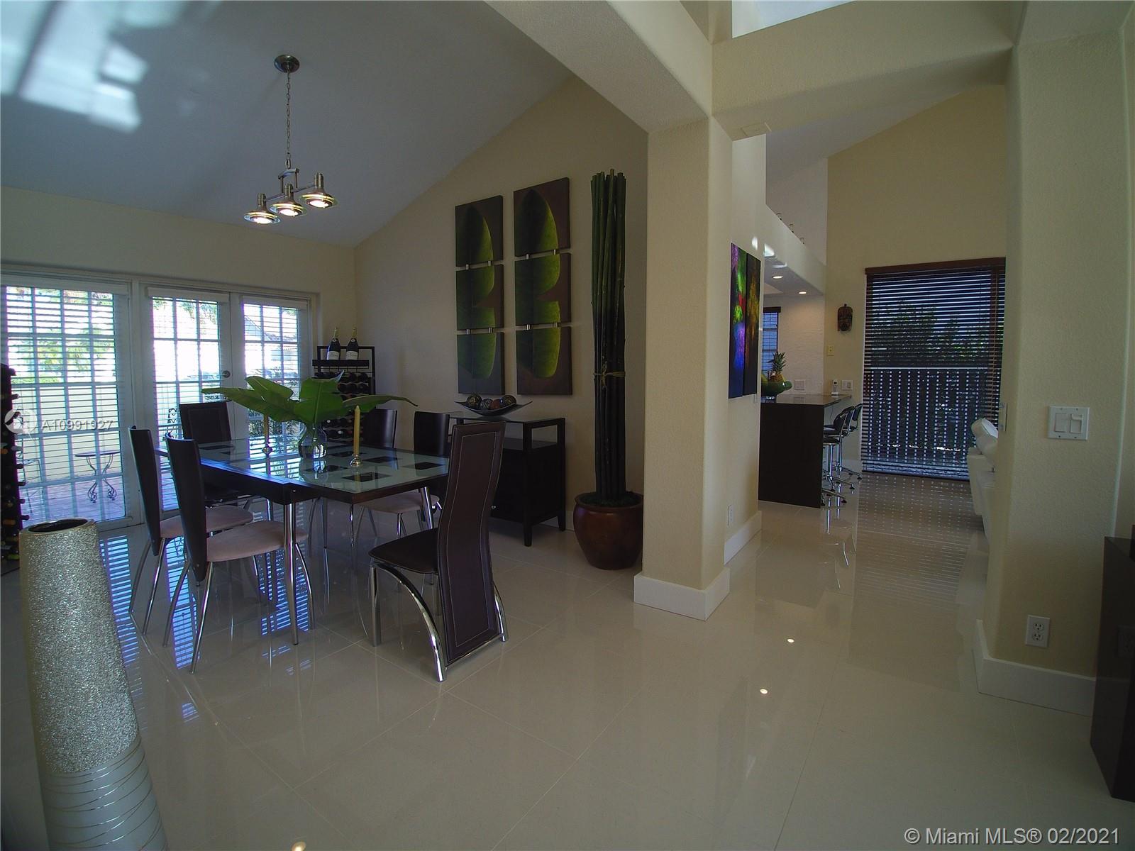 1055 San Luis Rey Weston, FL 33326 - Photo 7 of 36 a room with dining table and chairs