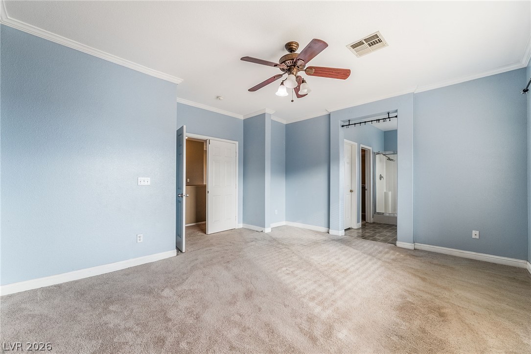 224 Positive Point Street Henderson, NV 89012 - Photo 24 of 44 Crown molding and soft carpeting elevate the potential of this light-filled primary suite.