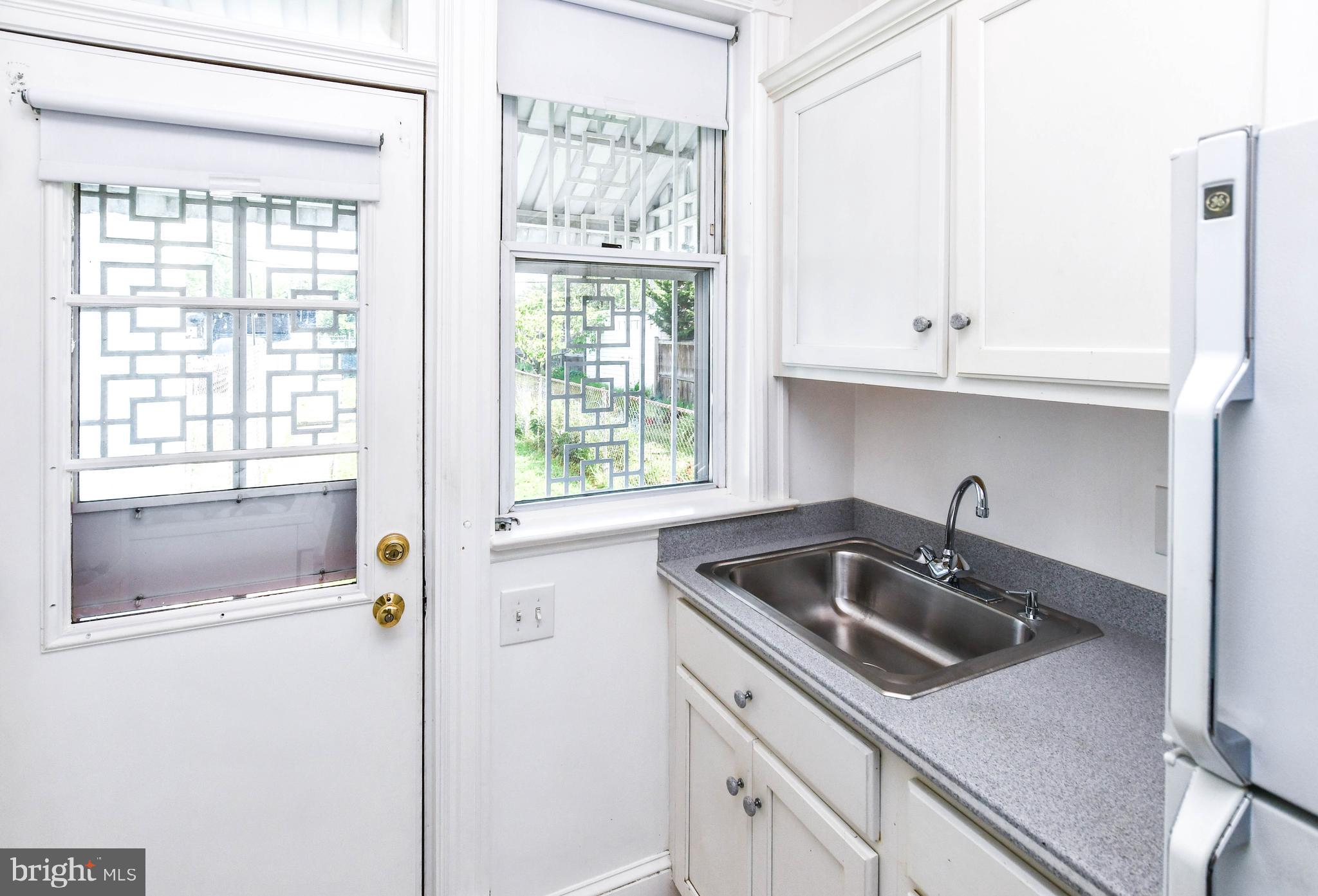 1432 C Street Southeast Washington, DC 20003 - Photo 17 of 48 a kitchen with a sink and cabinets