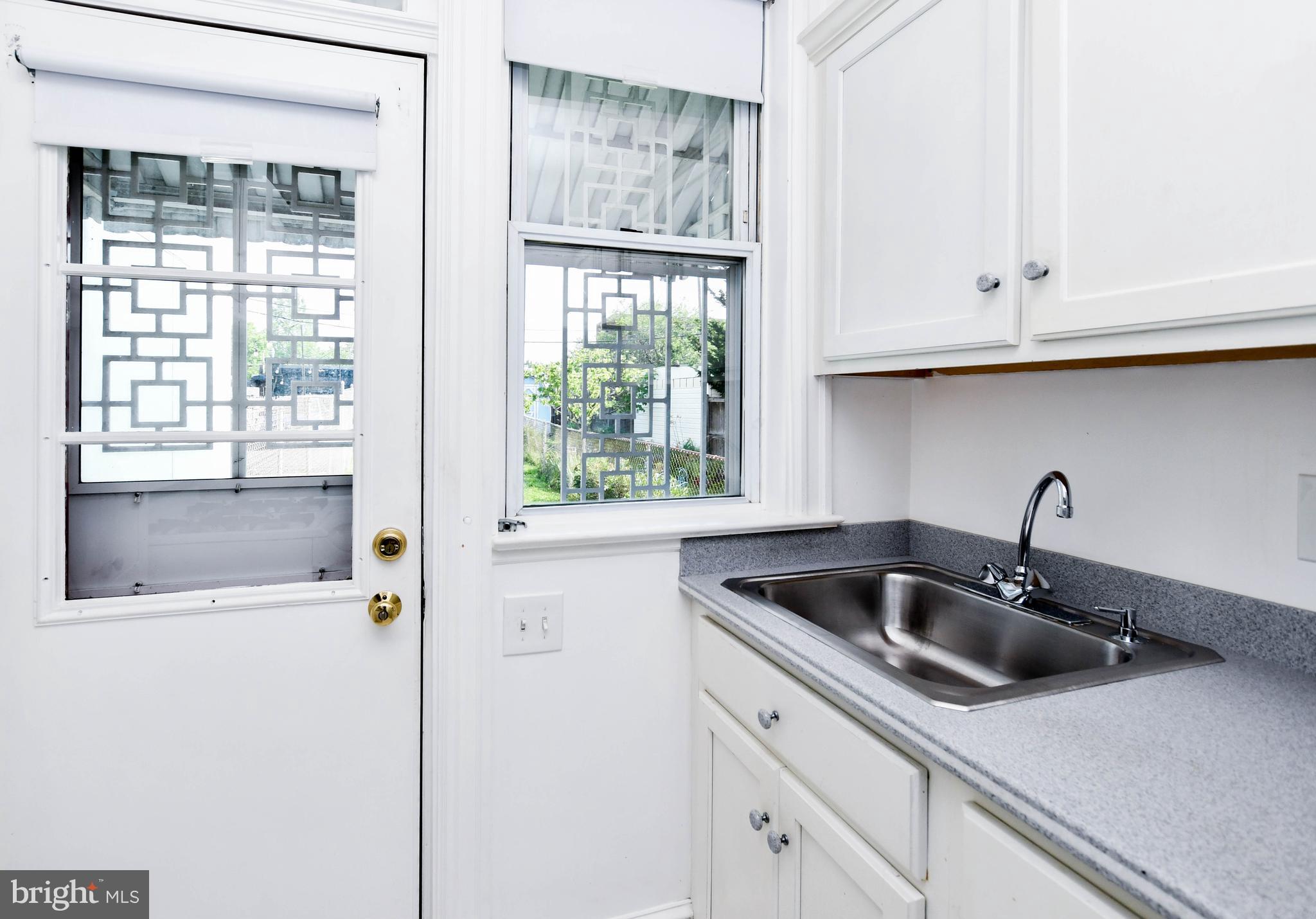 1432 C Street Southeast Washington, DC 20003 - Photo 18 of 48 a kitchen with a sink and cabinets