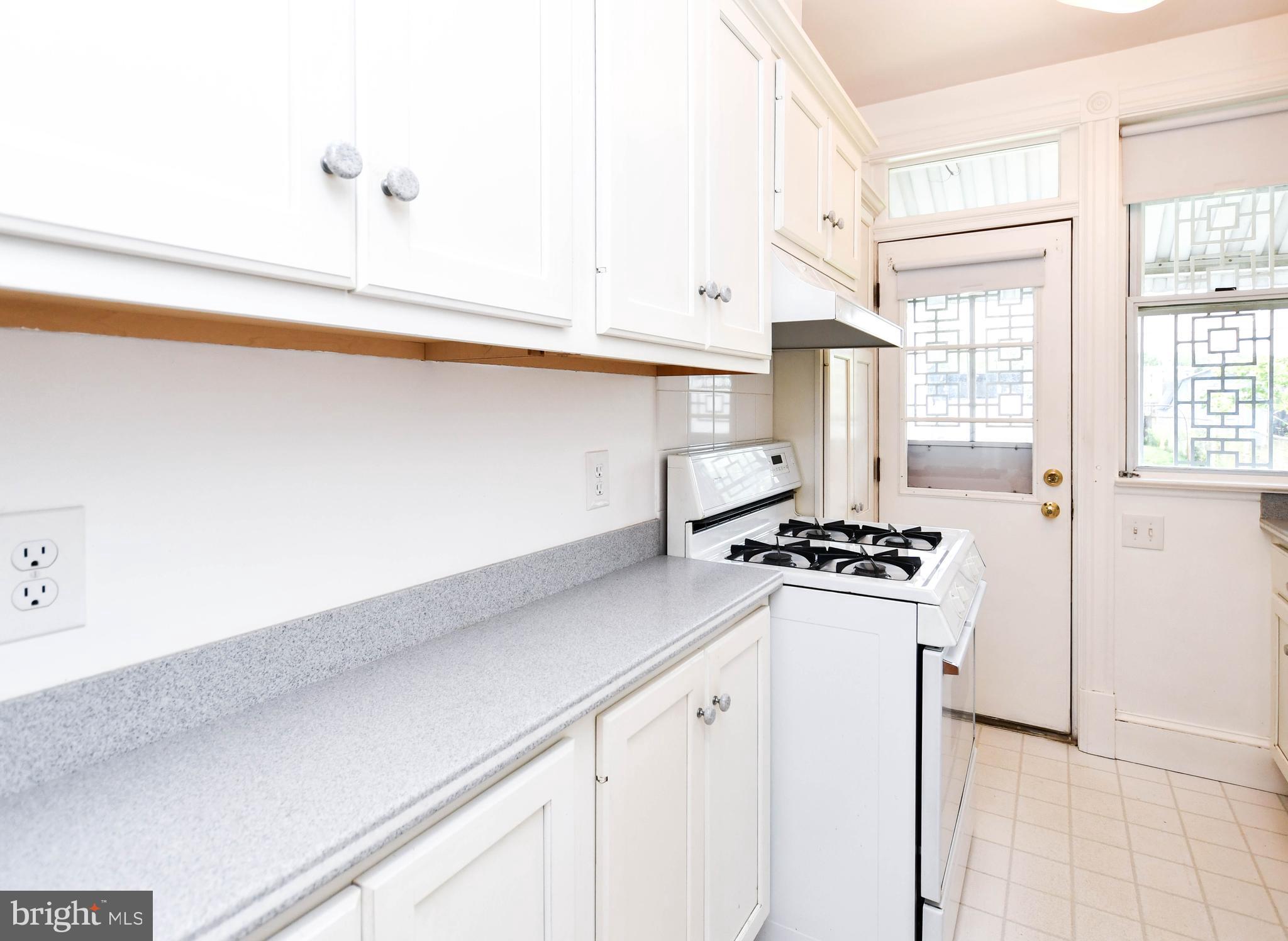 1432 C Street Southeast Washington, DC 20003 - Photo 19 of 48 a kitchen with granite countertop a sink stove and refrigerator