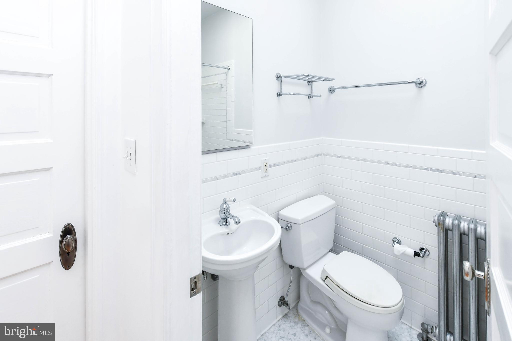 1432 C Street Southeast Washington, DC 20003 - Photo 22 of 48 a white toilet sitting next to a bathroom sink