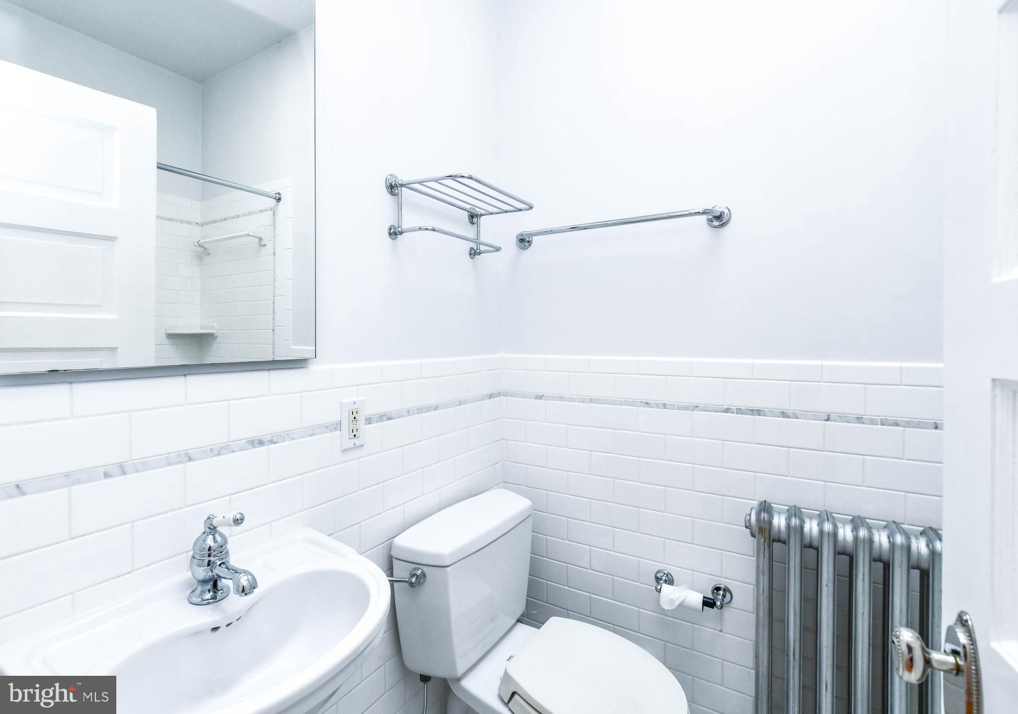 1432 C Street Southeast Washington, DC 20003 - Photo 23 of 48 a bathroom with a sink a toilet and mirror