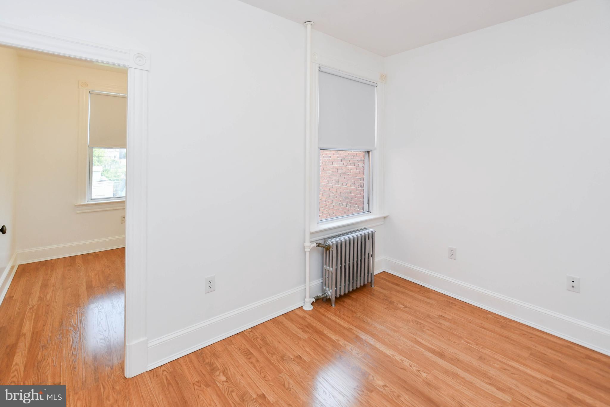 1432 C Street Southeast Washington, DC 20003 - Photo 29 of 48 a view of empty room with wooden floor and fan