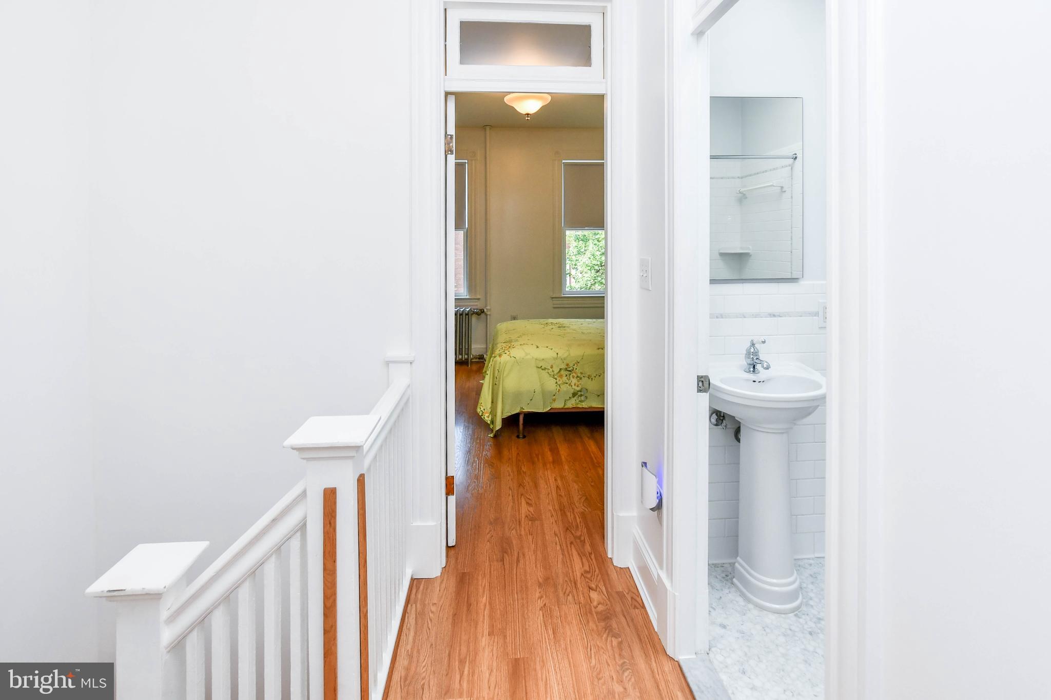 1432 C Street Southeast Washington, DC 20003 - Photo 31 of 48 a view of a hallway with wooden floor and staircase