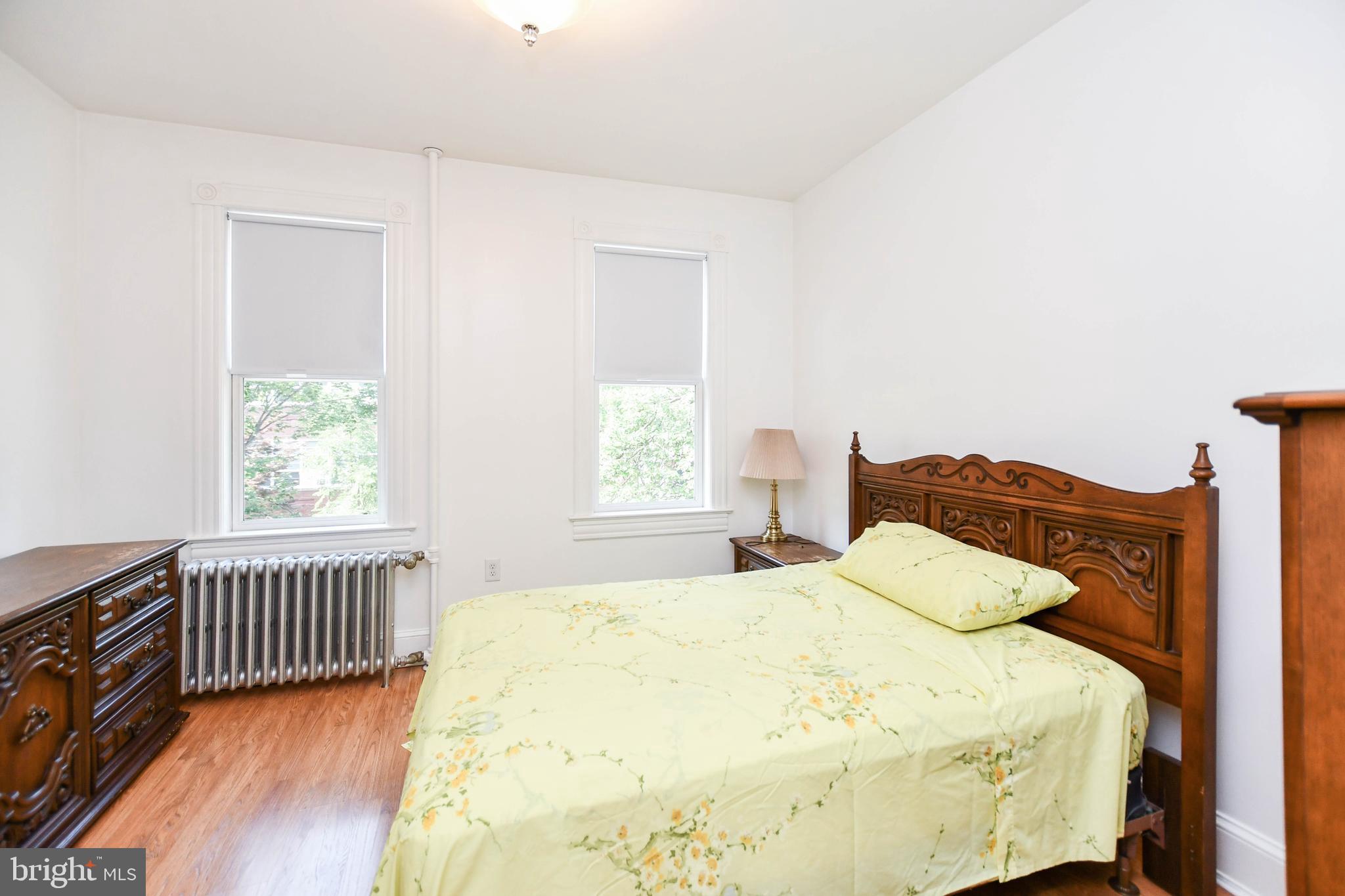 1432 C Street Southeast Washington, DC 20003 - Photo 32 of 48 a large bed sitting in a bedroom next to a window