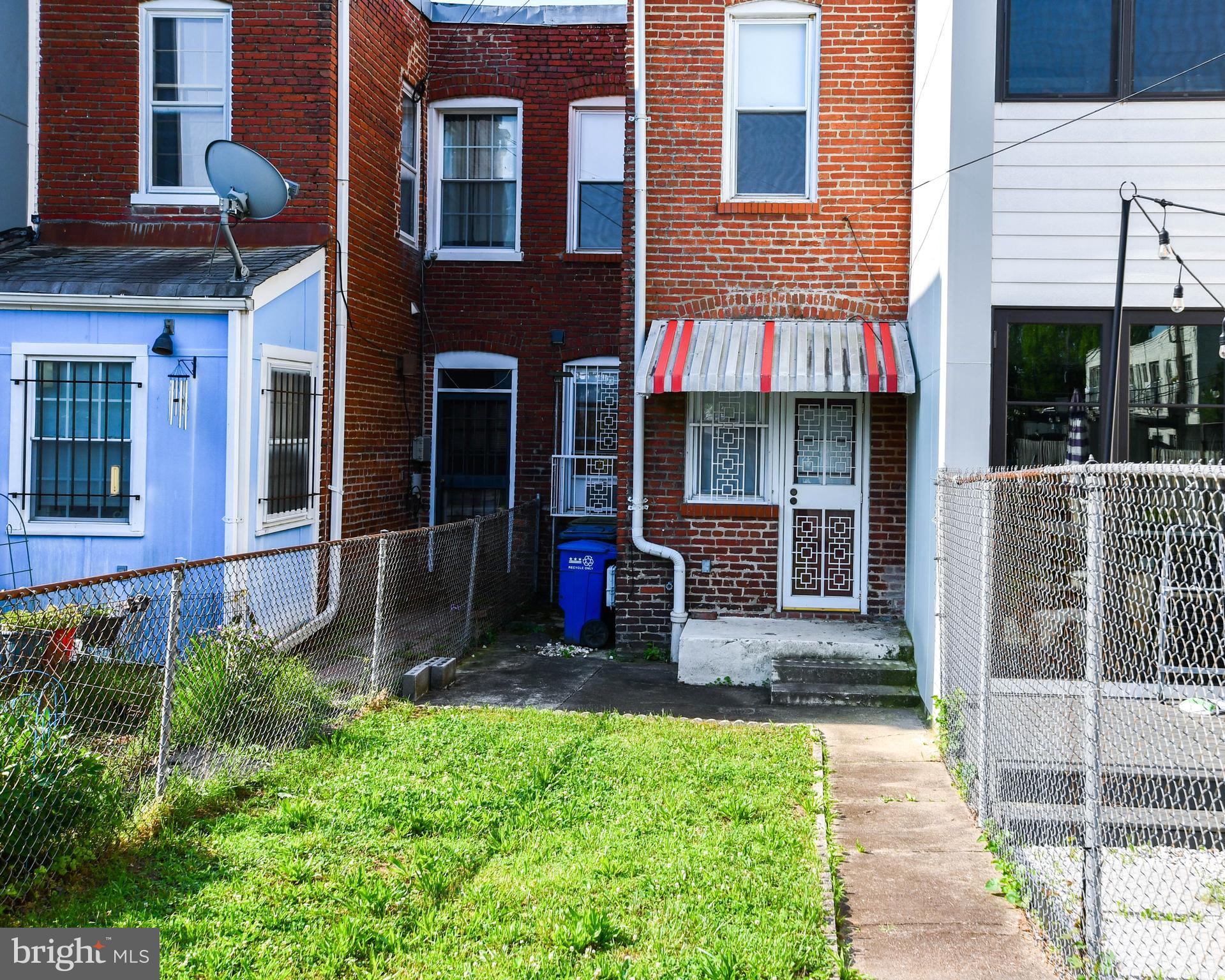 1432 C Street Southeast Washington, DC 20003 - Photo 36 of 48 a front view of a house with a yard