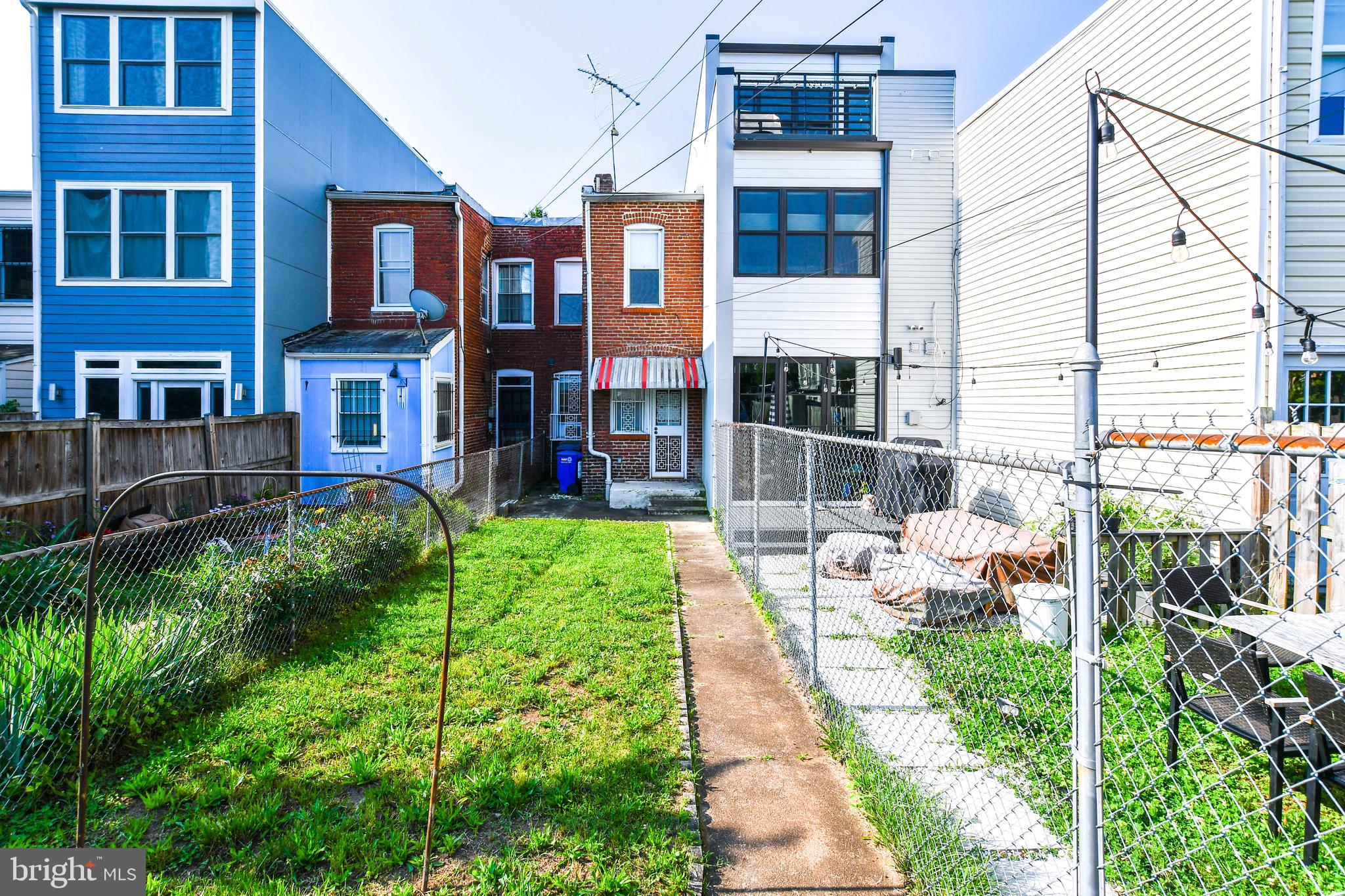 1432 C Street Southeast Washington, DC 20003 - Photo 37 of 48 a view of a chair and tables in the patio in front of a house