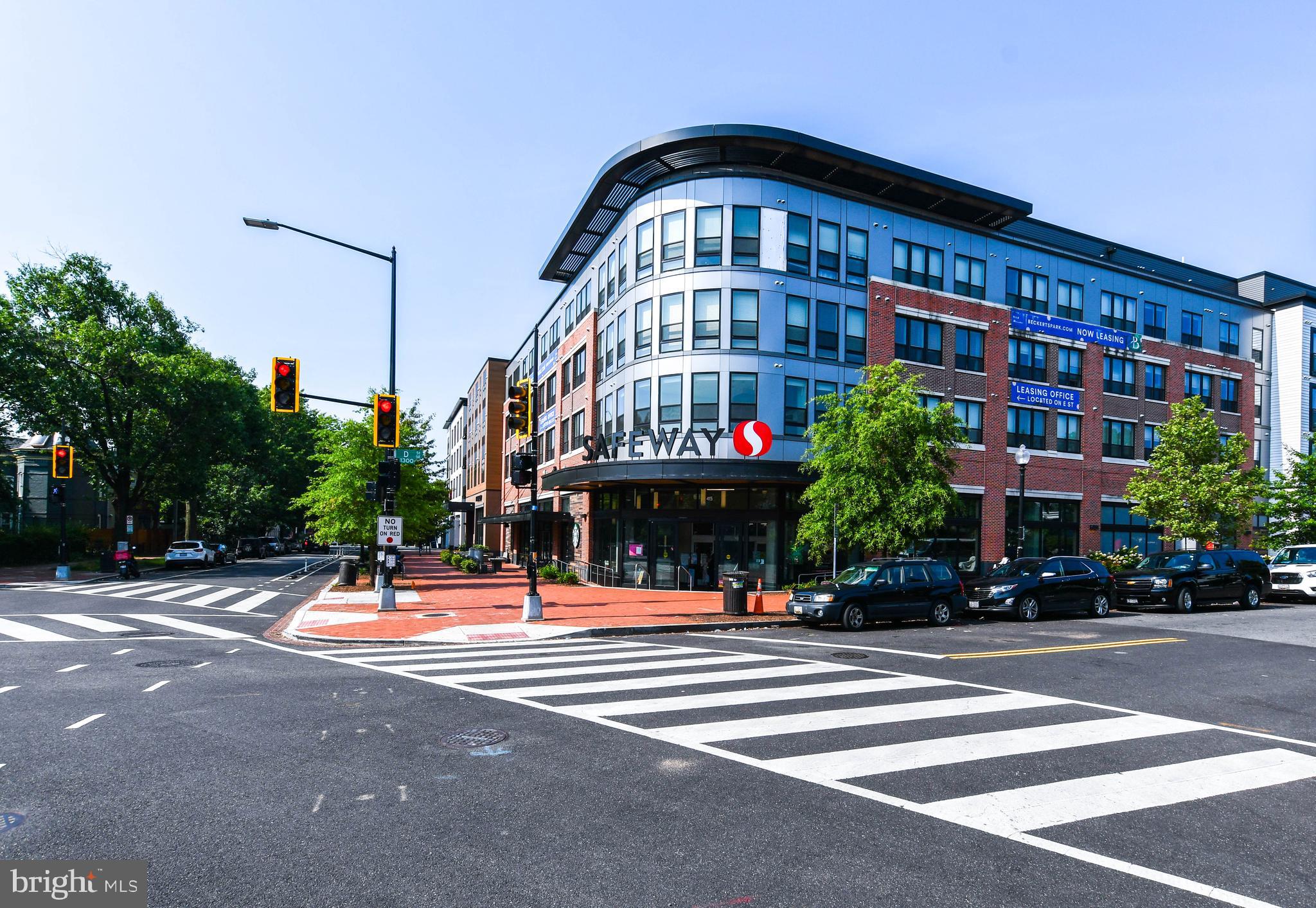 1432 C Street Southeast Washington, DC 20003 - Photo 47 of 48 a front view of multi story building with retail shops car and traffic signal