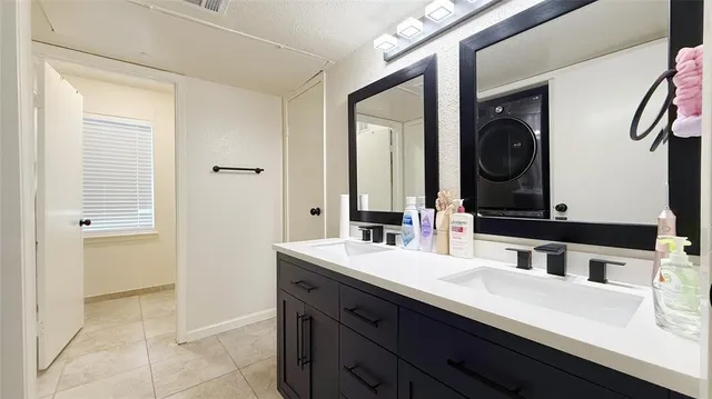 a bathroom with a double vanity sink and a mirror