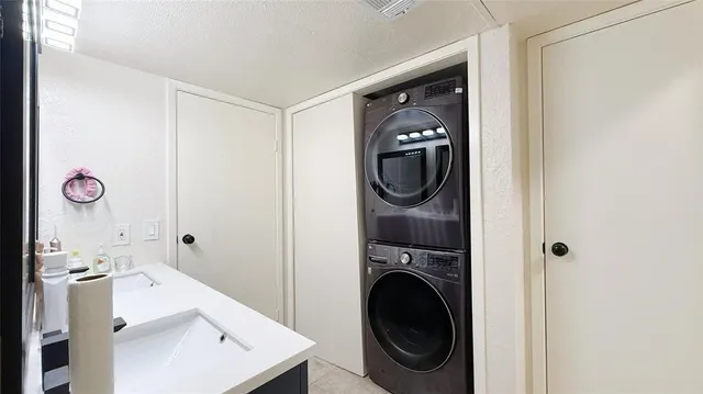 a utility room with a sink dryer and washer